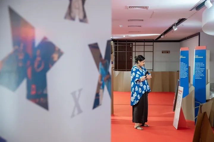 A guest walking past large TEDx letter cut-outs at a TEDxNapierBridge event