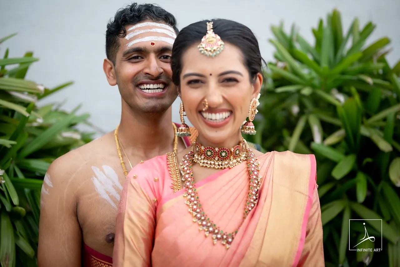 A Tamil bride and groom laughing together after their wedding ceremony